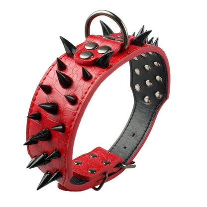 Vue inclinée d’un large collier clouté pour chien en cuir rouge avec longues pointes métalliques noires.
