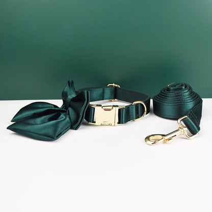 Ensemble collier et laisse pour chien vert foncé avec nœud détachable présenté devant un fond vert et blanc.