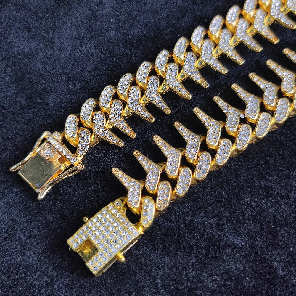 Gros plan d’un collier doré pour chien avec strass et pointes sur fond noir.