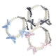 Collection de colliers fantaisie pour chiot en perles nacrées avec rubans à carreaux en trois coloris sur fond blanc.