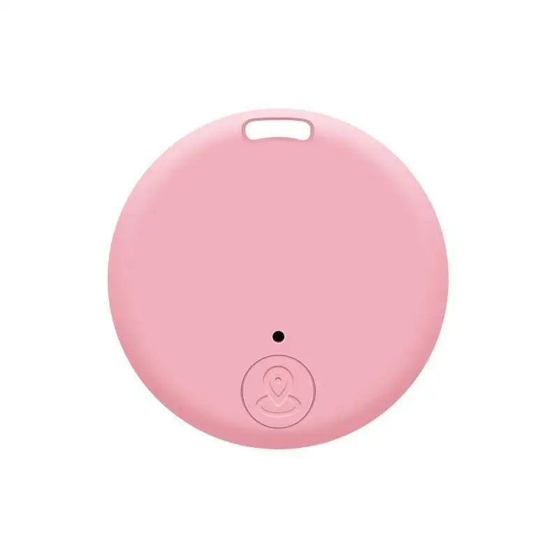 Traceur Bluetooth anti-perte rond en coloris rose, avec œillet de fixation en haut et bouton central arrondi avec icône de localisation sur fond blanc.