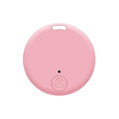 Traceur Bluetooth anti-perte rond en coloris rose, avec œillet de fixation en haut et bouton central arrondi avec icône de localisation sur fond blanc.